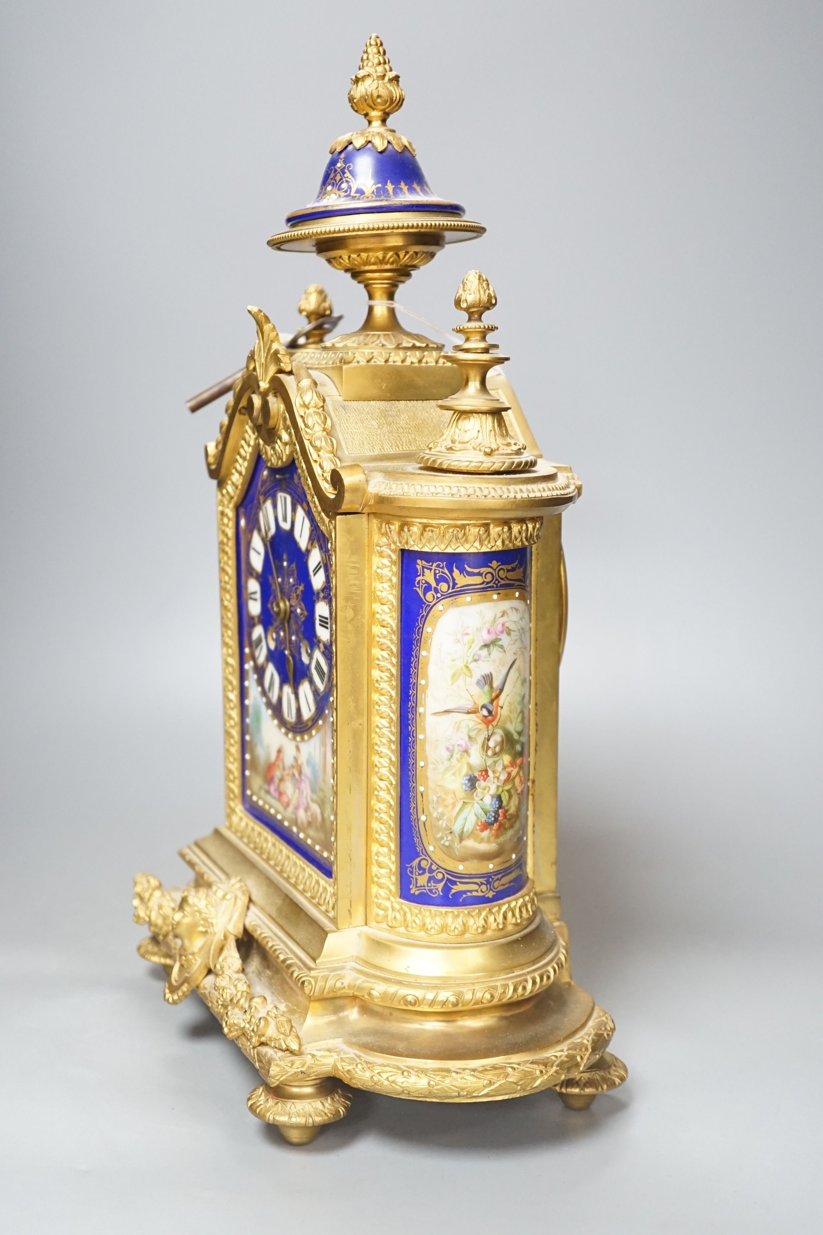 A 19th century French ormolu cased mantel clock, with decorated porcelain panels and face, eight day movement with strike, 40cm high